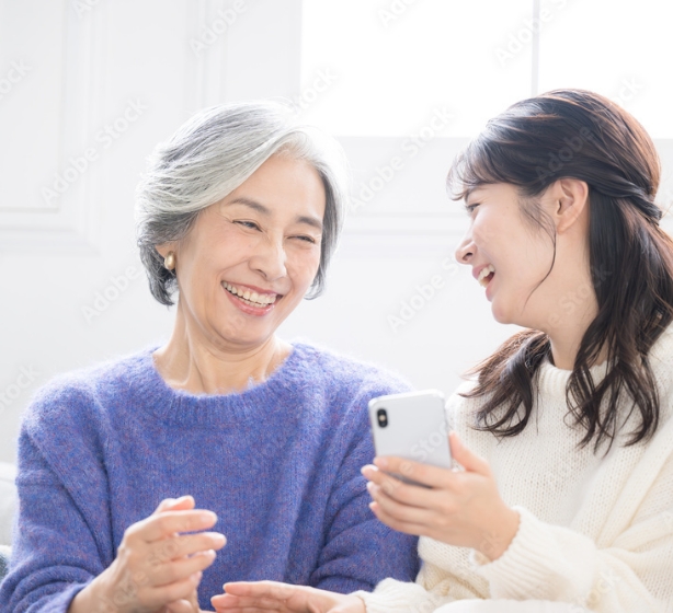 スマホを見て笑顔になる人々